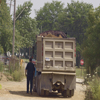 Truck driver beside his truck, loading up supplies